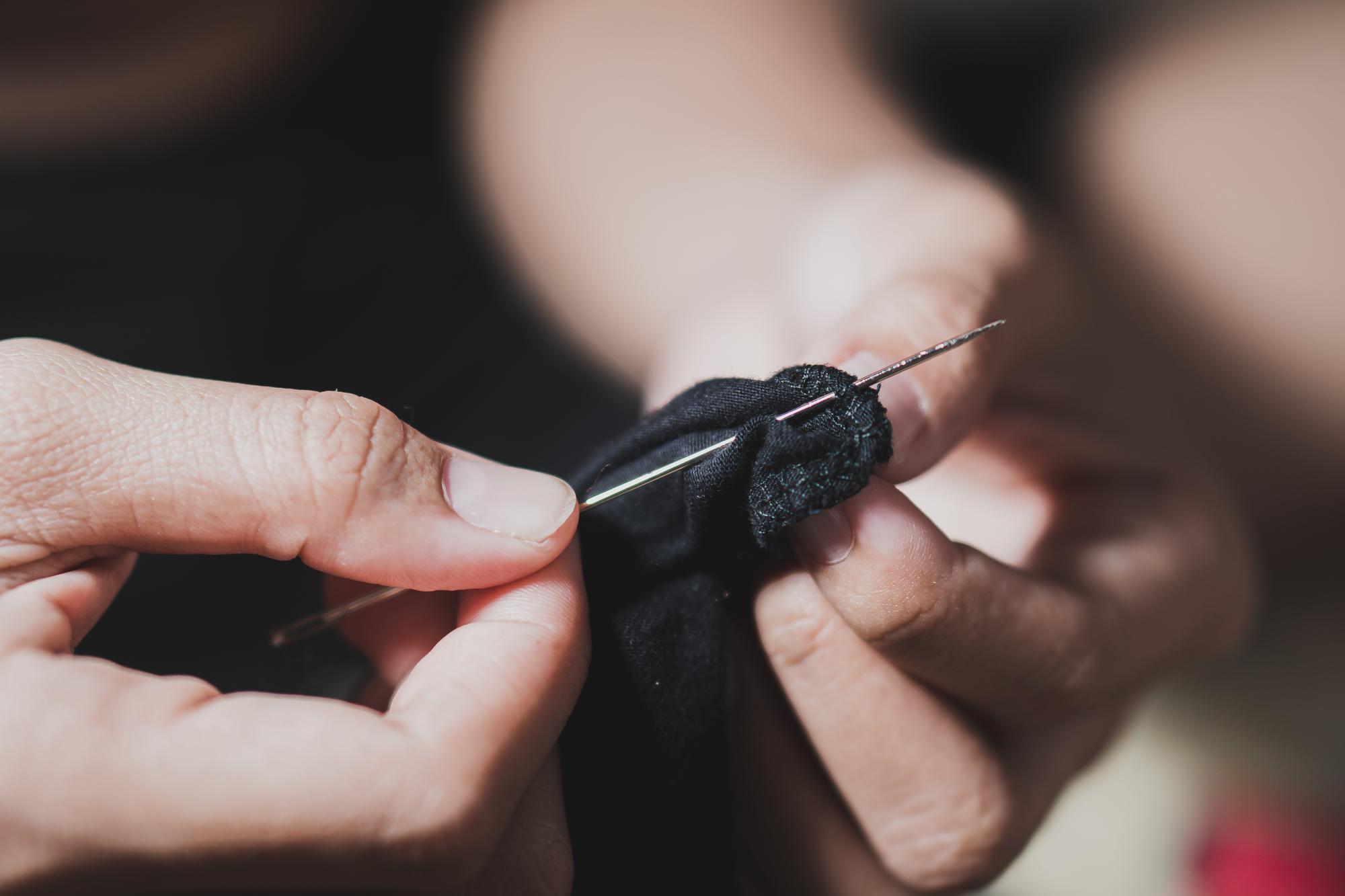 Hands stitching closeup